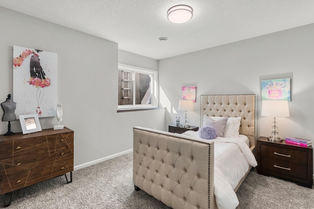 bedroom featuring light carpet and a textured ceiling