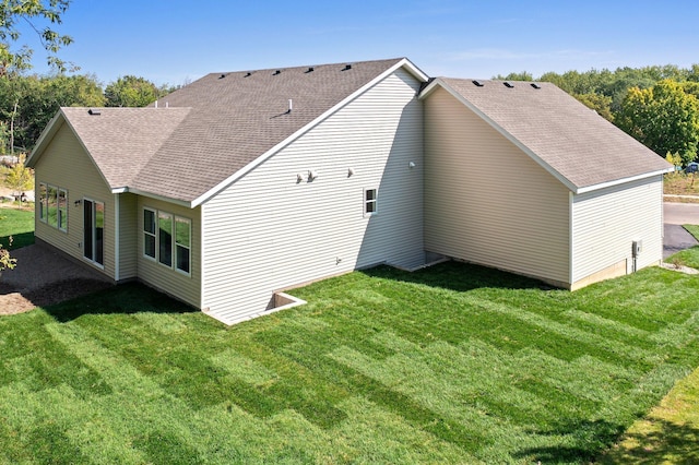 rear view of property with a yard