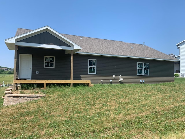 rear view of property featuring a yard