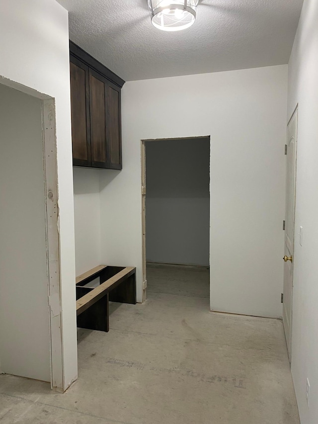 mudroom with a textured ceiling