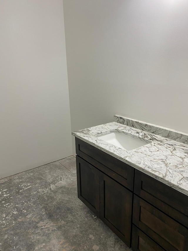 bathroom featuring concrete floors and vanity