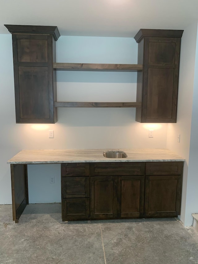 kitchen with dark brown cabinetry and sink