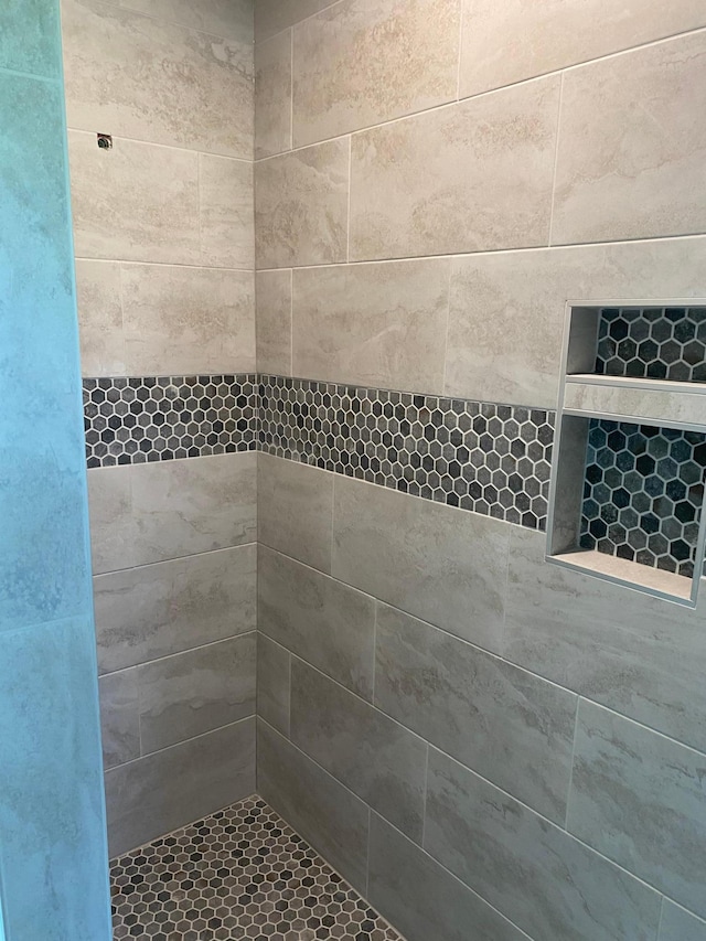 bathroom with a tile shower