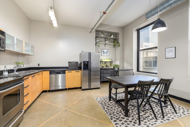 kitchen featuring pendant lighting, appliances with stainless steel finishes, and sink