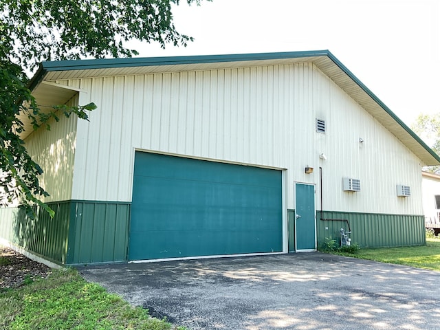 view of home's exterior with a wall mounted AC