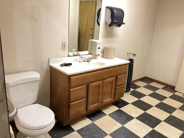 bathroom featuring vanity, tile patterned flooring, and toilet