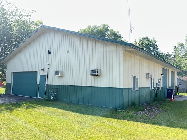 view of side of property with a garage and a lawn