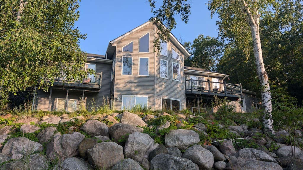 back of property featuring a wooden deck