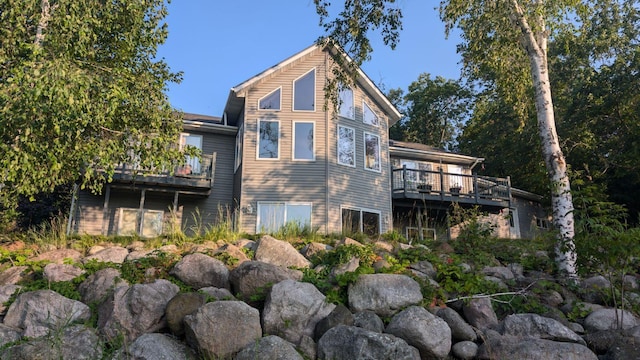 back of property featuring a wooden deck