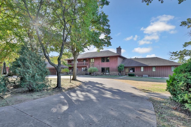 10834 178th Cir NW, Elk River, MN 55330 - view of front of home with curved driveway, a chimney, and stone siding
