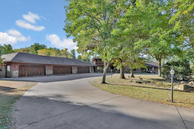 10834 178th Cir NW, Elk River, MN 55330 - view of front of home featuring stone siding, driveway, and a garage