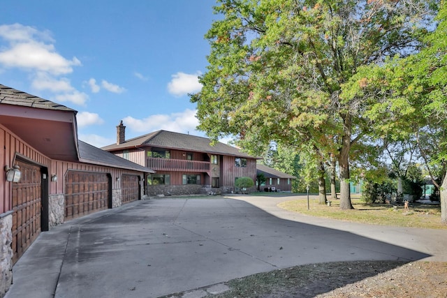 10834 178th Cir NW, Elk River, MN 55330 - view of front of house with driveway, stone siding, and a garage