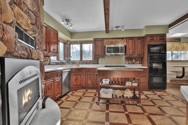 10834 178th Cir NW, Elk River, MN 55330 - kitchen featuring black appliances, track lighting, light countertops, a sink, and a textured ceiling
