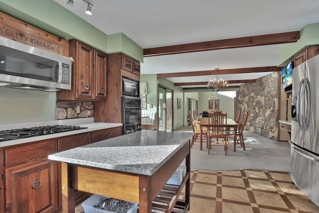 10834 178th Cir NW, Elk River, MN 55330 - kitchen with black appliances, a chandelier, decorative light fixtures, a kitchen island, and beam ceiling