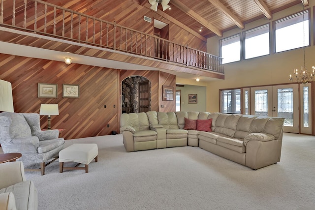 10834 178th Cir NW, Elk River, MN 55330 - carpeted living room featuring high vaulted ceiling, wooden ceiling with exposed beams, arched walkways, a chandelier, and wooden walls