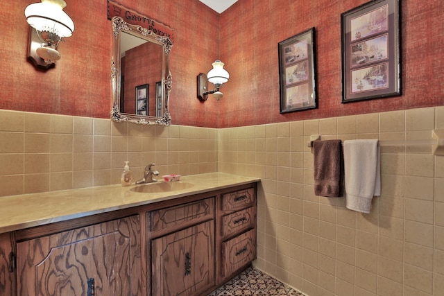 10834 178th Cir NW, Elk River, MN 55330 - bathroom featuring wallpapered walls, vanity, tile walls, and a wainscoted wall