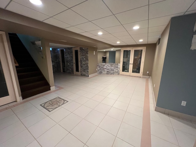 10834 178th Cir NW, Elk River, MN 55330 - finished basement with stairway, french doors, a drop ceiling, light tile patterned floors, and recessed lighting