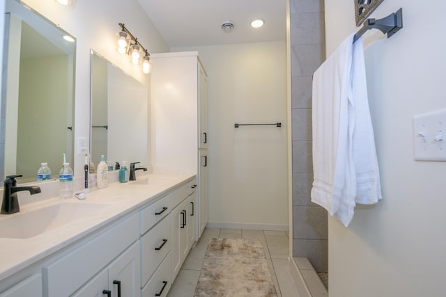 bathroom with tile patterned flooring and vanity