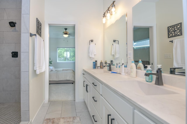 bathroom featuring tiled shower, vanity, tile patterned floors, and ceiling fan