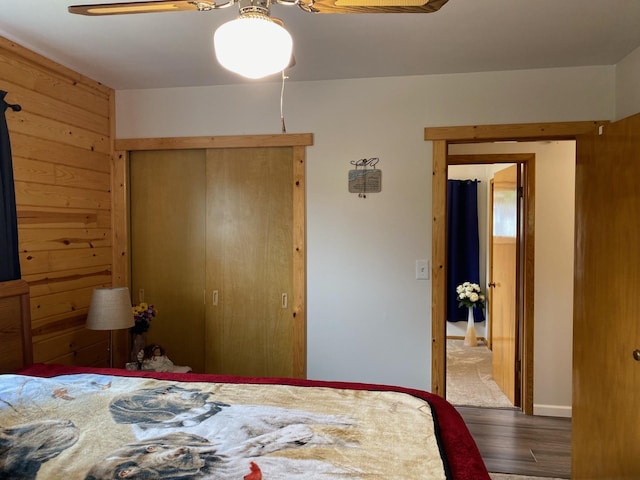 bedroom with ceiling fan, hardwood / wood-style floors, and a closet