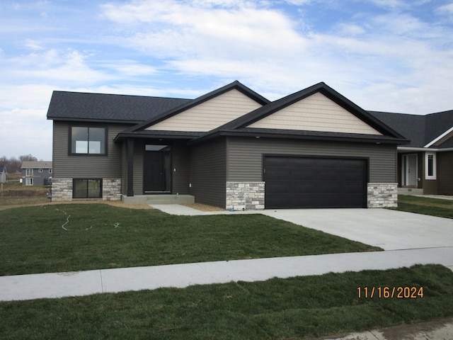 view of front of house featuring a front yard and a garage