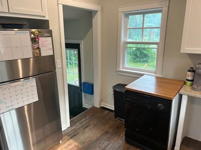 kitchen with white cabinets, dishwasher, stainless steel fridge, and dark wood-type flooring