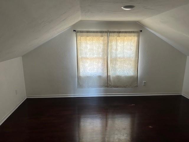 bonus room featuring vaulted ceiling and hardwood / wood-style flooring