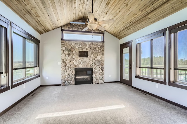 unfurnished living room with vaulted ceiling, ceiling fan, a fireplace, and carpet flooring