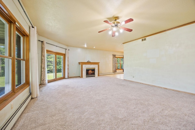 unfurnished living room featuring ceiling fan, a high end fireplace, a textured ceiling, baseboard heating, and light carpet