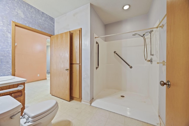 bathroom with walk in shower, vanity, and toilet