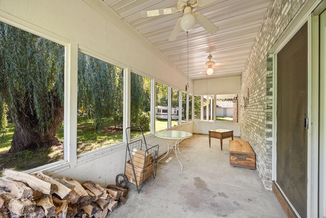 unfurnished sunroom with ceiling fan