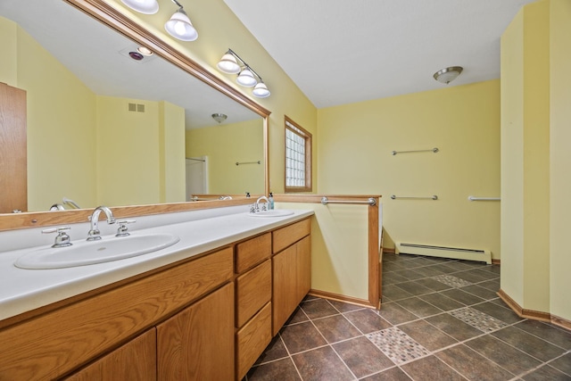 bathroom featuring tile patterned flooring, vanity, and baseboard heating