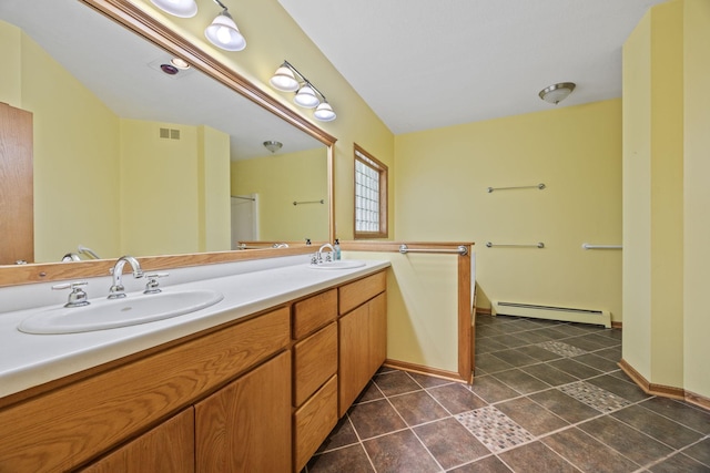 full bath featuring a baseboard heating unit, double vanity, visible vents, and a sink