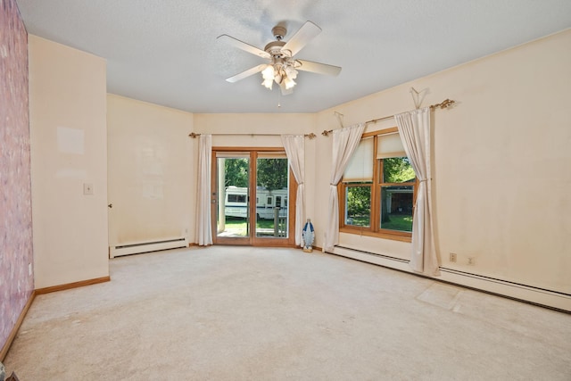 empty room with light colored carpet, ceiling fan, baseboard heating, and a textured ceiling