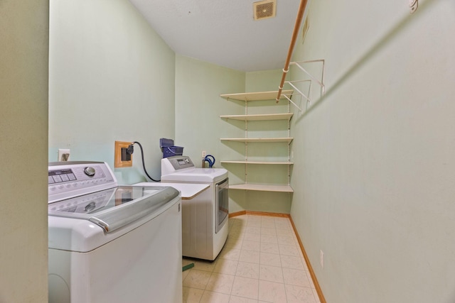 clothes washing area with washing machine and clothes dryer