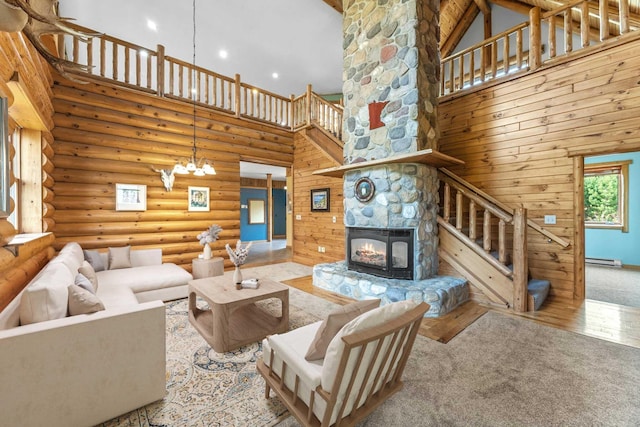 carpeted living room featuring high vaulted ceiling, a baseboard heating unit, a stone fireplace, and log walls