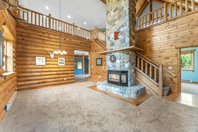 unfurnished living room with high vaulted ceiling, light colored carpet, and log walls