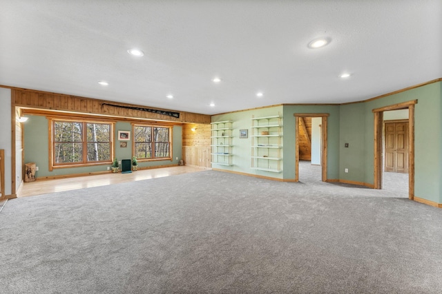 unfurnished living room with light carpet and ornamental molding