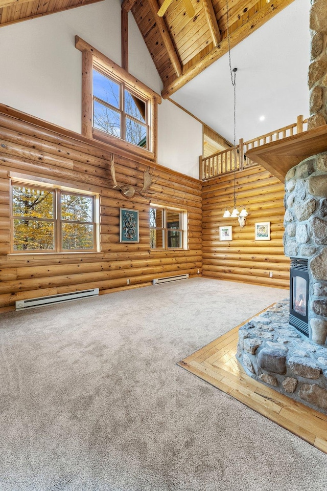 unfurnished living room featuring a baseboard radiator, beamed ceiling, carpet flooring, high vaulted ceiling, and wooden ceiling