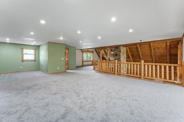 unfurnished room featuring a wealth of natural light and carpet floors