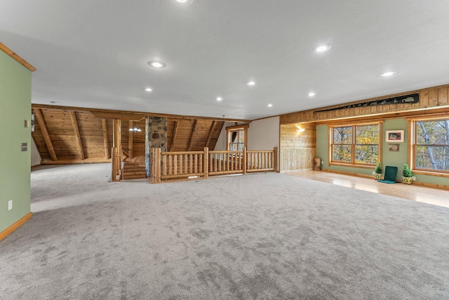 interior space featuring crown molding, light colored carpet, and wood walls