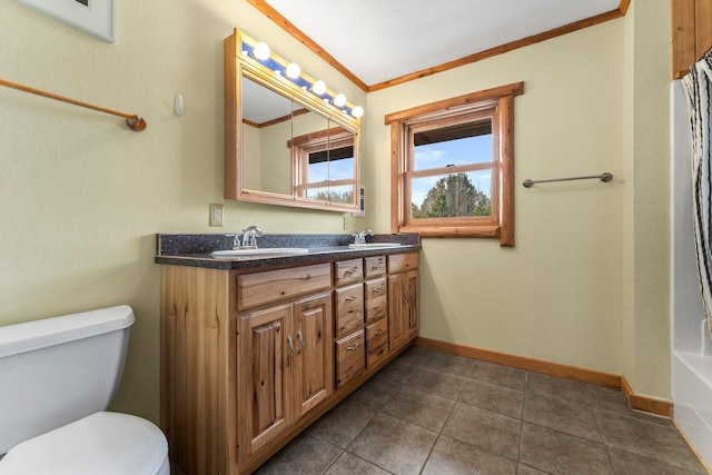 bathroom featuring toilet, crown molding, and vanity