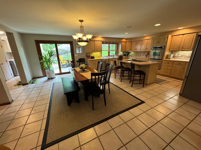 tiled dining area featuring a notable chandelier