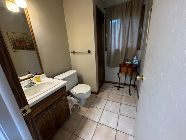 bathroom featuring vanity, toilet, and tile patterned flooring