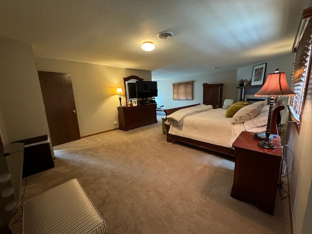 bedroom featuring carpet floors and a textured ceiling