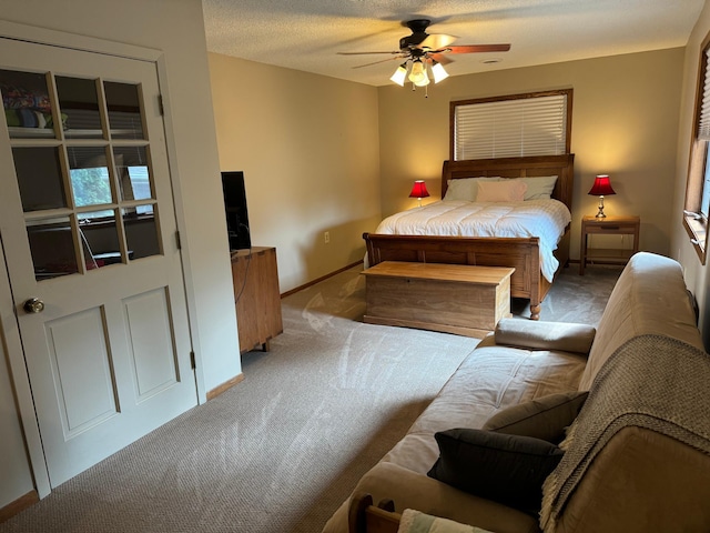 carpeted bedroom featuring a textured ceiling and ceiling fan