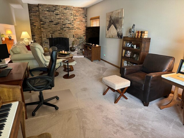 carpeted office with a fireplace and brick wall