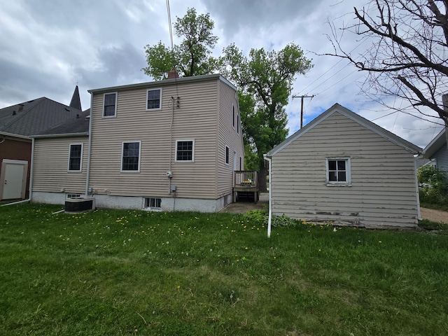 219 4th St SE, Pipestone, MN 56164 - back of house with a lawn, central AC, and a chimney
