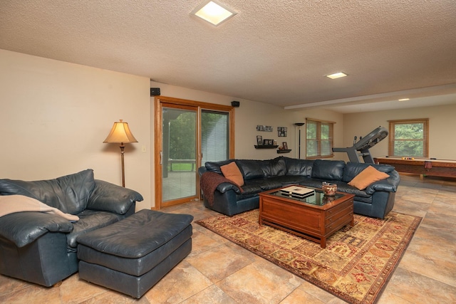 living room with pool table and a textured ceiling