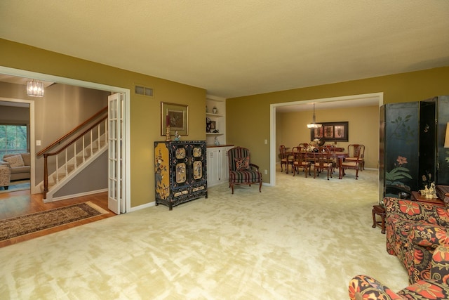 interior space featuring a textured ceiling, a chandelier, and built in features